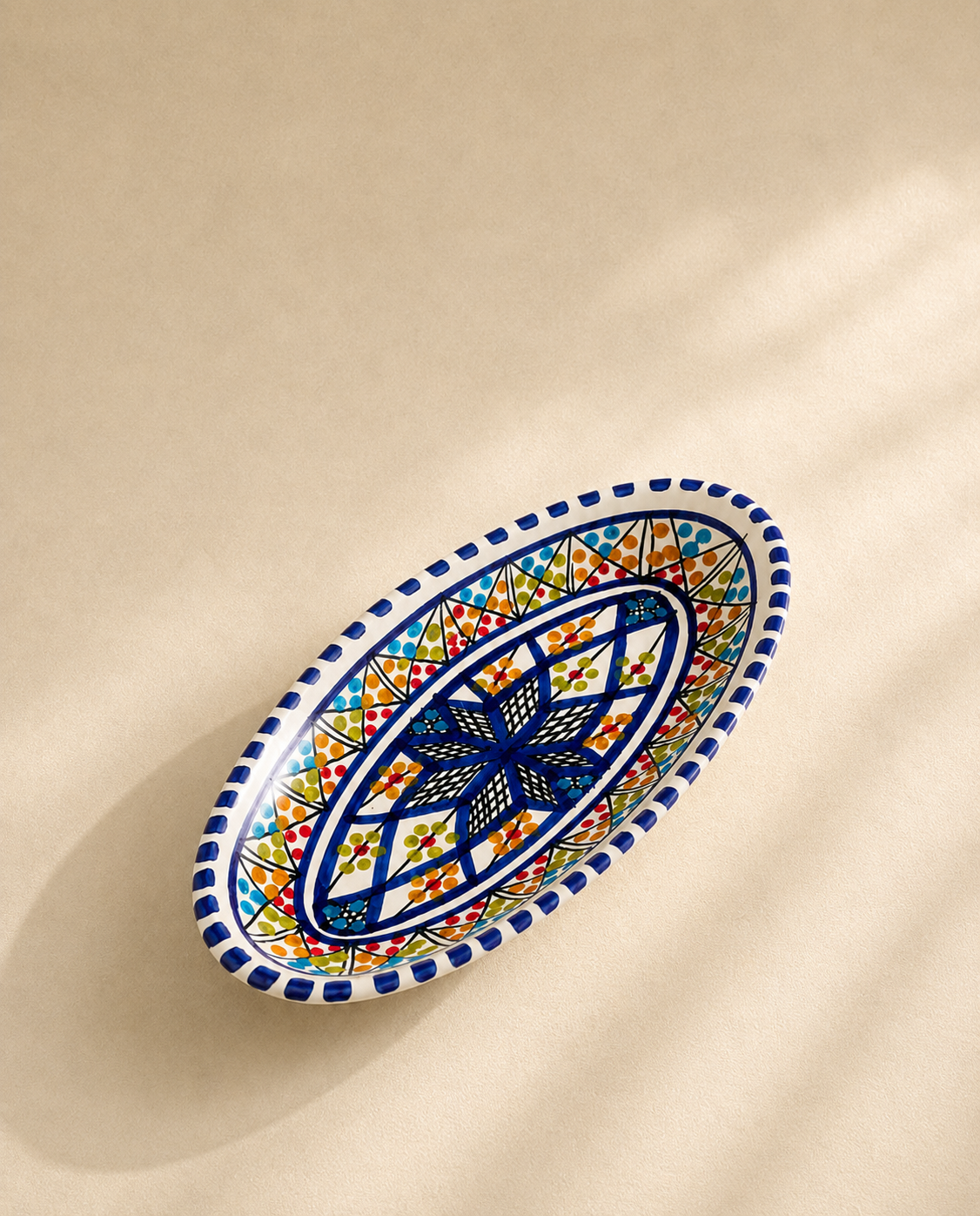 Petit plat ovale en céramique artisanale tunisienne de la collection Médina vu de profil.